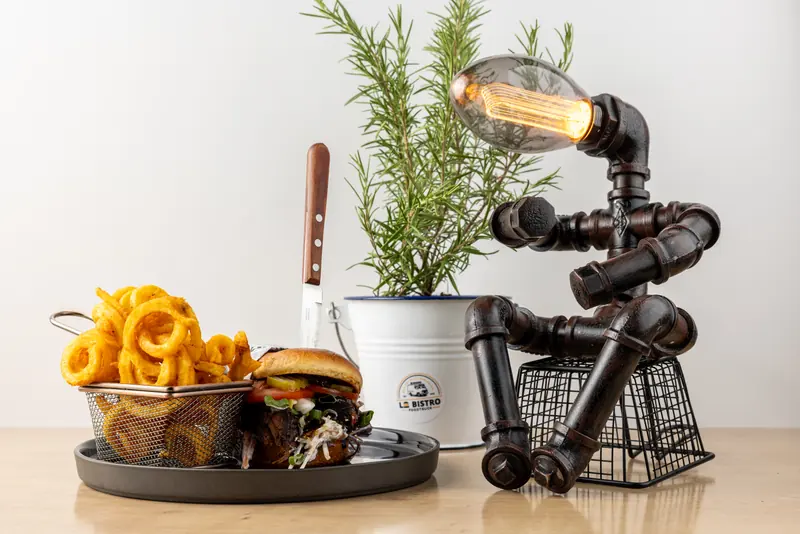 Foodtruck-Catering mit Deko: TS1952 Burger und Curly Fries vor Rosmarin und einer Lampe aus Eisenrohren